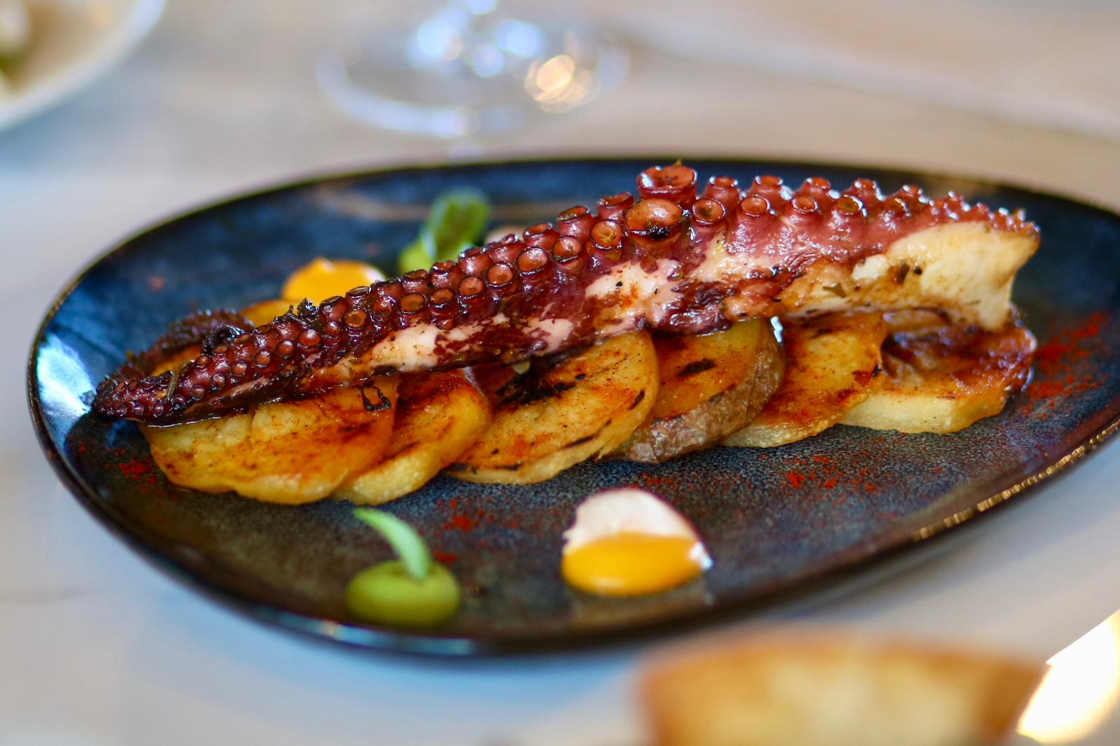 Tomahawk steak sliced on slate board, being presented